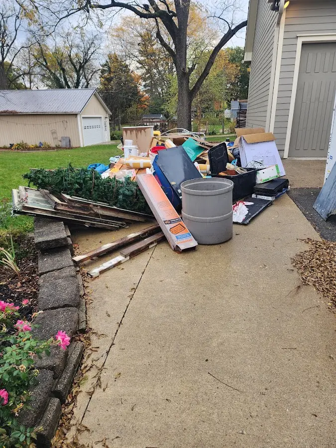 Dumpster being loaded with debris for 12 Yard Dumpster Rental in Sterling
